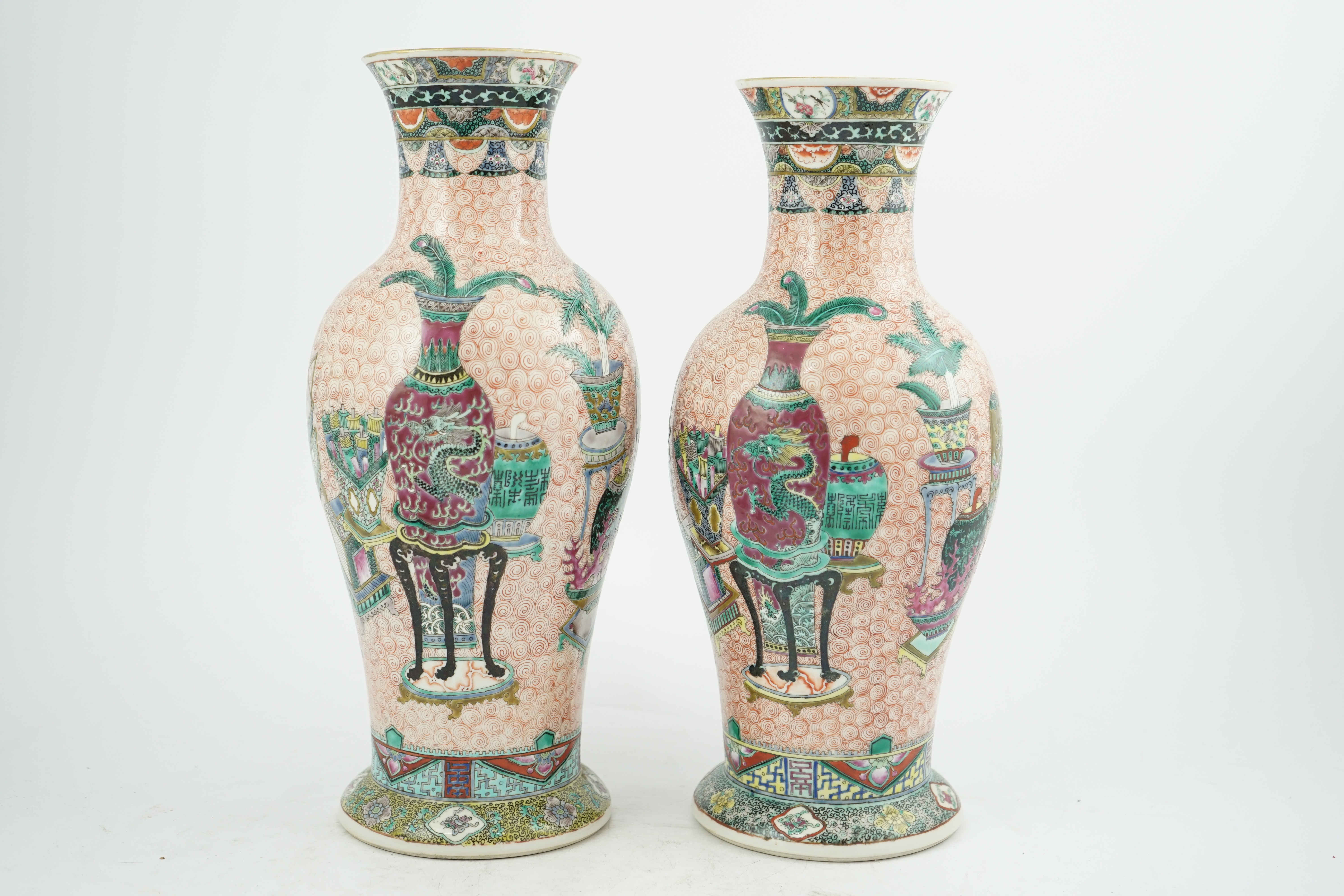 A near pair of Chinese famille rose ‘Hundred Antiques’ baluster vases, Kangxi mark, early 20th century